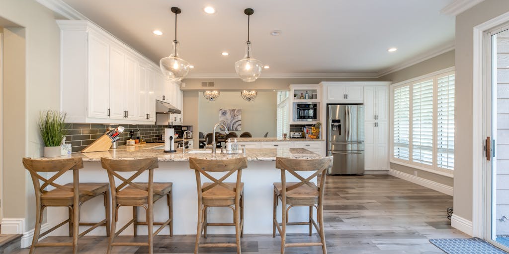 A split-screen image. On one side, a chaotic, brightly lit kitchen counter covered in spills, crumbs, and dirty dishes. On the other side, the same counter, now sparkling clean and organized, with a bottle of Clorox wipes subtly placed in the background. The lighting on the clean side is softer and more inviting. The contrast highlights the transformative power of Clorox in a relatable, everyday scenario.