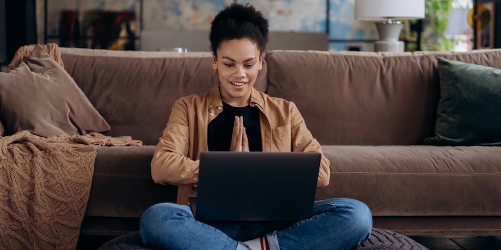 A split-screen image showing two contrasting work environments: on one side, a cozy home office with a person working in pajamas, surrounded by plants and personal items; on the other side, a bustling corporate office with employees collaborating at a conference table. This visual representation highlights the duality of hybrid work.