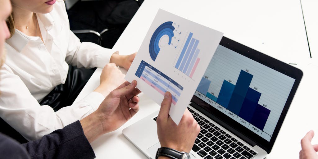 A vibrant workspace featuring a laptop open to a digital marketing course, surrounded by colorful sticky notes, a coffee cup, and a plant. The screen displays graphs and analytics, symbolizing the data-driven nature of digital marketing.