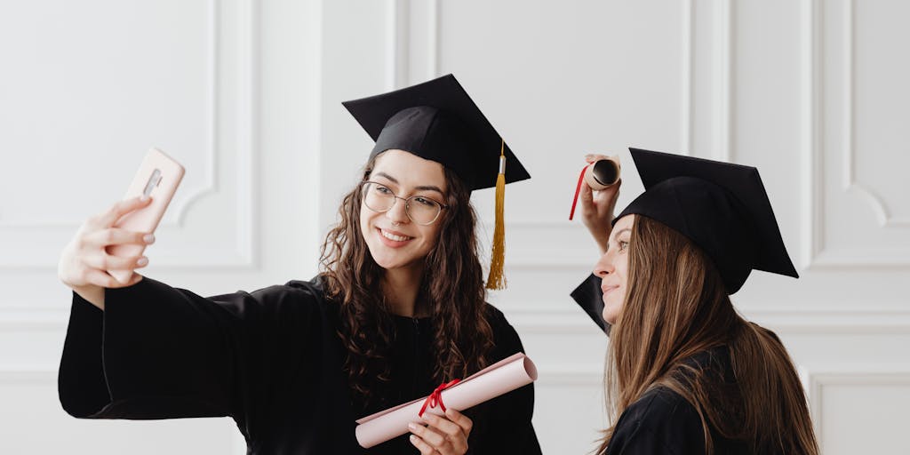 A close-up shot of a person holding a diploma in one hand while using a smartphone in the other, with a blurred background of a cityscape. This symbolizes the transition from education to the practical application of digital marketing skills in the real world.