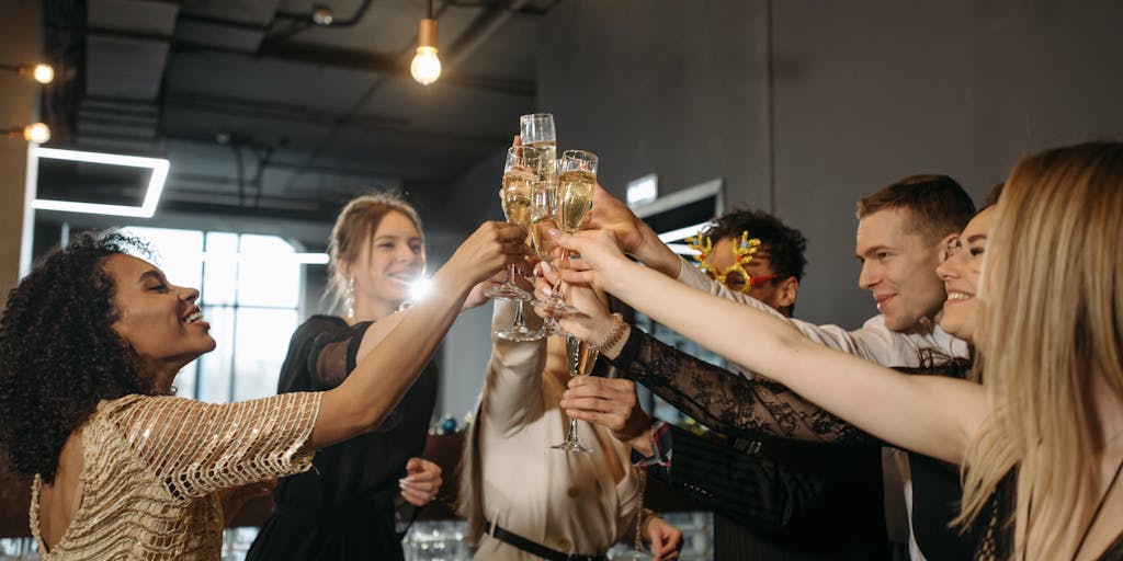 A dynamic photo of a small business team celebrating a successful TikTok campaign. They are gathered around a laptop, watching their video go viral, with expressions of joy and excitement. The background features their products and a banner that says 'TikTok Success!' to emphasize the achievement.