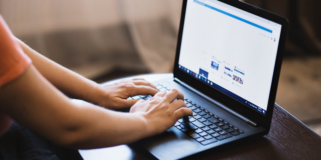 A split-screen image showing a user on a laptop with Facebook open on one side and Instagram on the other. The user is depicted in the act of clicking a 'Share' button on Facebook, with arrows indicating the flow of content from Facebook to Instagram. The background is bright and colorful, symbolizing the vibrant nature of social media.