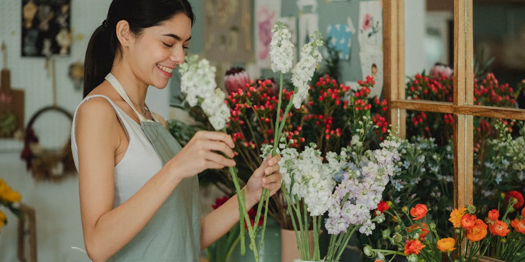 A vibrant photo of a small business owner engaging with customers at a local craft fair. Capture the seller's booth filled with unique handmade items, with customers browsing and interacting. The atmosphere should be lively, showcasing the personal connection between the seller and buyers, emphasizing community engagement.