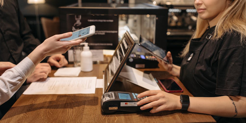 A dynamic image of a person using a smartphone to browse the AliExpress app, with a shopping cart icon and product images floating around them. The background should be a cozy home setting, illustrating the convenience of online shopping and the appeal of AliExpress's marketing strategy.