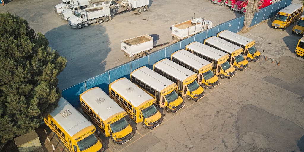 An aerial shot of a Carvana car lot with a diverse range of vehicles neatly organized. The image should include a digital overlay of statistics or infographics that represent Carvana's market reach and customer satisfaction, emphasizing their data-driven marketing approach.