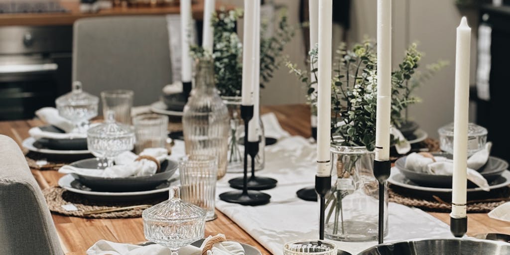 An overhead shot of a beautifully set dining table with a smartphone displaying the OpenTable app. The table is adorned with gourmet dishes and elegant tableware, emphasizing the premium dining experience that OpenTable promotes. The image should convey a sense of luxury and sophistication.