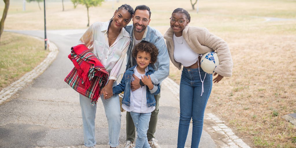 A vibrant outdoor scene featuring a diverse group of people wearing Bonobos clothing, enjoying a picnic in a park. The focus is on the relaxed, stylish nature of the clothing, with a backdrop of greenery and sunlight filtering through the trees. This image captures the essence of community and lifestyle that Bonobos promotes through its marketing strategy.