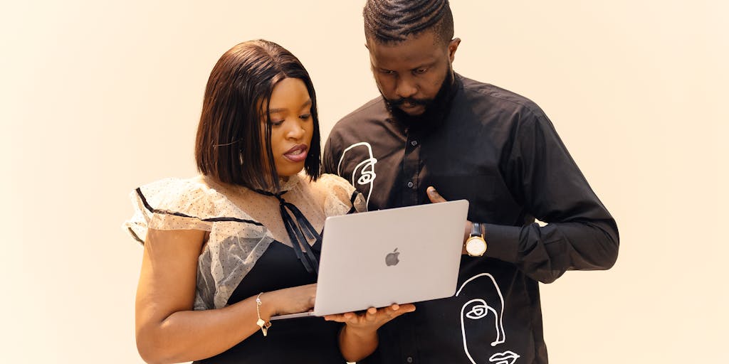 A dynamic photo of a diverse group of young professionals brainstorming in a modern office space, with The Hut Group branding subtly integrated into the environment. Capture the energy and collaboration that reflects the innovative marketing strategies of the company, with digital devices and marketing materials scattered around.