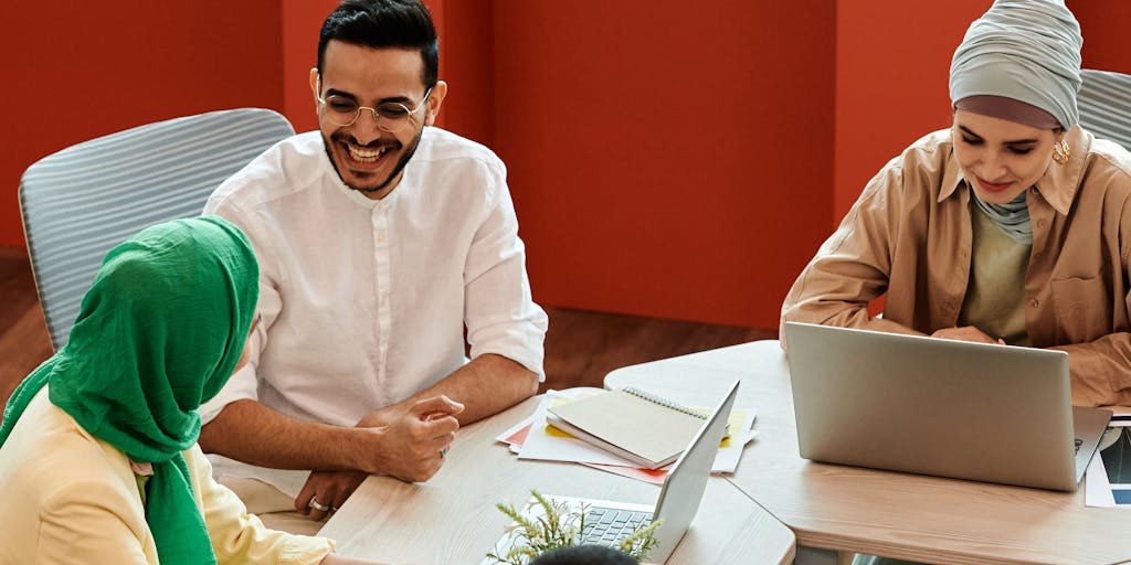 A futuristic office space with a large digital screen displaying real-time analytics and marketing data. A diverse team of professionals is gathered around a table, brainstorming ideas while using tablets and laptops. The atmosphere is vibrant and collaborative, showcasing the integration of technology in marketing strategies.