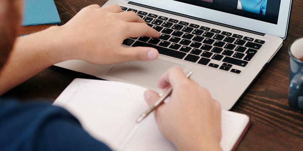 An overhead shot of a diverse group of people sitting around a table, each using different devices (laptops, tablets, smartphones) with the Dropbox logo visible on their screens. This image should capture the essence of remote work and the flexibility that Dropbox offers to teams across various platforms.