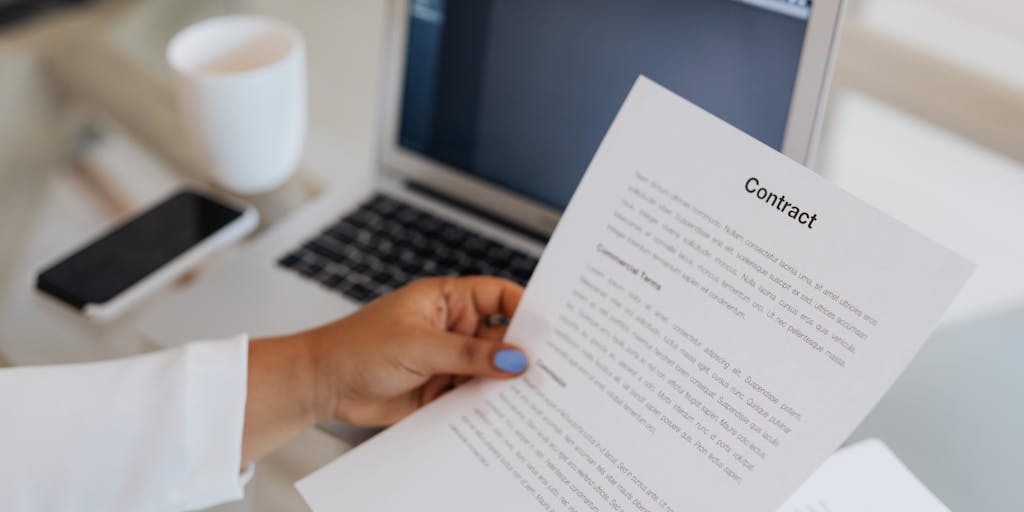 A split image showing a person signing a paper contract on one side and the same person digitally signing a DocuSign document on the other. This visual contrast highlights the transition from traditional to digital signing methods.