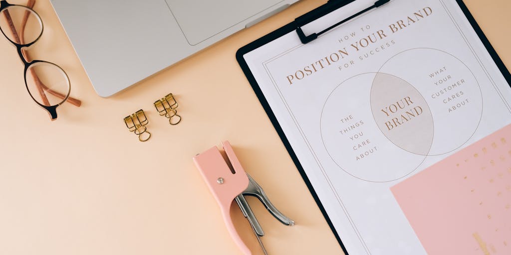 A creative flat lay of a marketing strategy planner open to a page filled with notes and sketches about customer journey mapping. Surrounding the planner are Zendesk products, such as a branded mug and a notebook, illustrating the planning process in a visually appealing way.