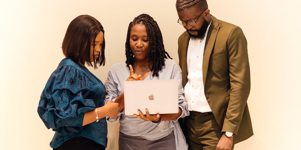 A vibrant brainstorming session in a modern office space, featuring a diverse team of marketers gathered around a large whiteboard filled with colorful sticky notes and diagrams. The atmosphere is energetic, showcasing collaboration and creativity in developing a GitLab marketing strategy.