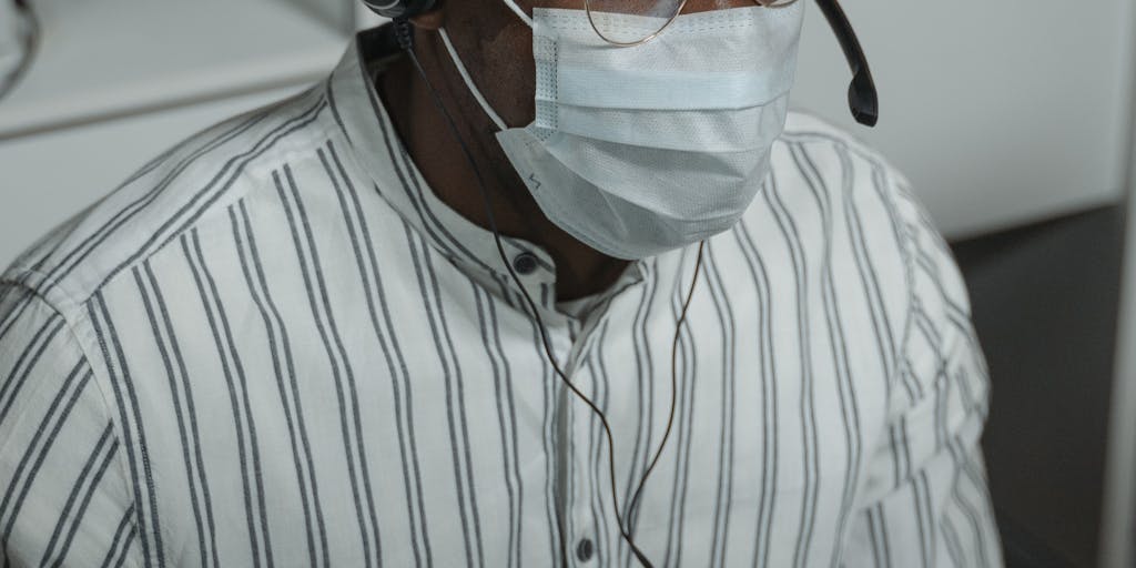 A dynamic image of a customer service representative wearing a headset, actively engaging with a customer through an intercom system. The background shows a modern office environment with motivational posters about customer engagement. This photo highlights the human element of intercom marketing and the importance of personal interaction.