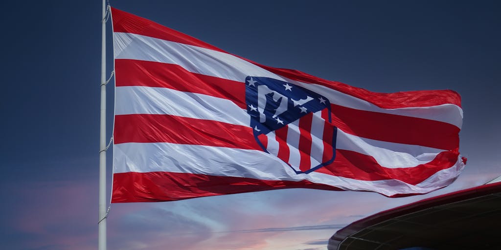 A dynamic action shot of Atletico Madrid players celebrating a goal, with confetti falling around them. This image symbolizes the excitement and emotional connection the club fosters with its fans, showcasing the effectiveness of their marketing campaigns.