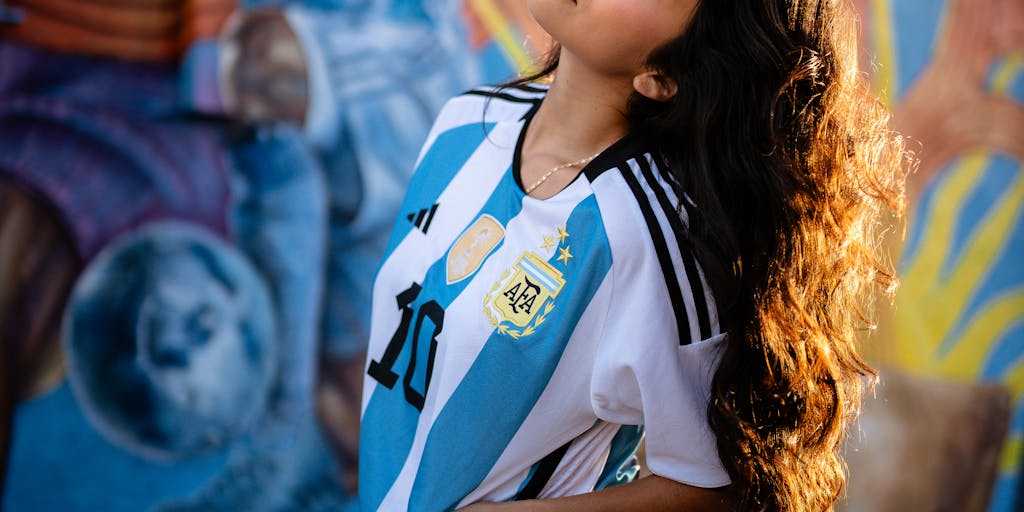 A close-up of a Manchester City jersey with a unique fan-designed patch or artwork, symbolizing the club's collaboration with local artists and fans. This photo represents the club's strategy to foster creativity and community involvement in its branding efforts.