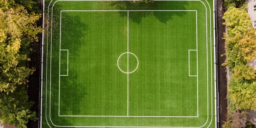 An overhead shot of a packed Johan Cruyff Arena during a match, with a digital overlay displaying real-time social media interactions and marketing campaigns. This image should illustrate the integration of technology and fan engagement in Ajax's marketing strategy.