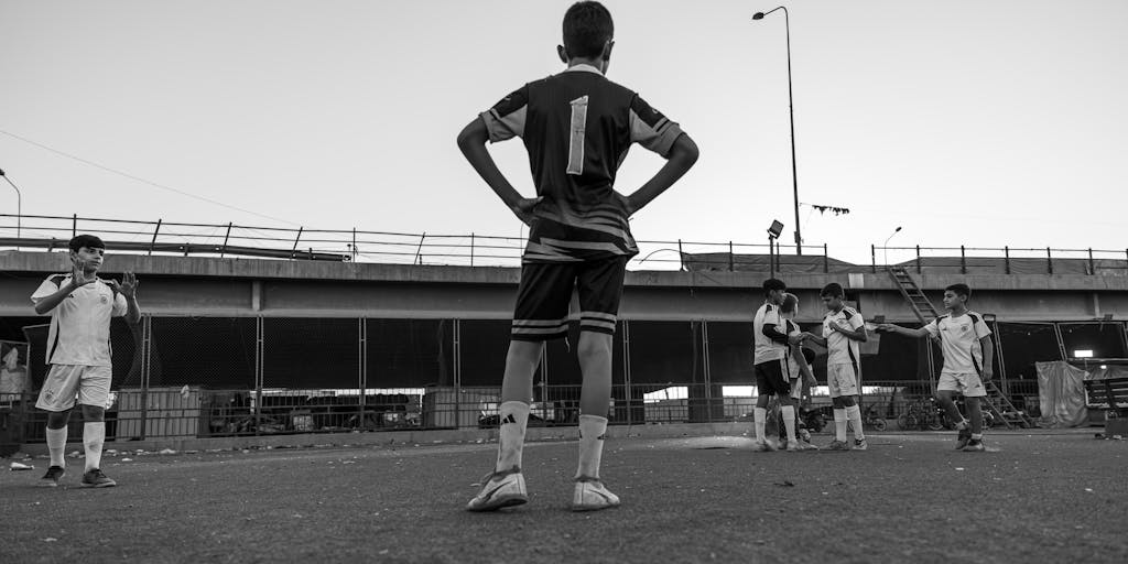 A dynamic action shot of a youth football training session featuring kids wearing FC Porto kits. The image should capture the enthusiasm and energy of the young players, highlighting FC Porto's commitment to youth development and community engagement.