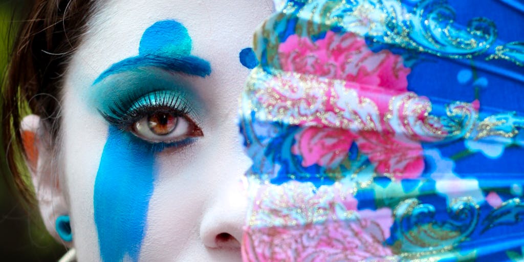 A close-up shot of a young fan painting their face in Rangers colors, with a look of determination and excitement. This image symbolizes the passion of the next generation of supporters and can be used in campaigns aimed at youth engagement and community outreach programs.