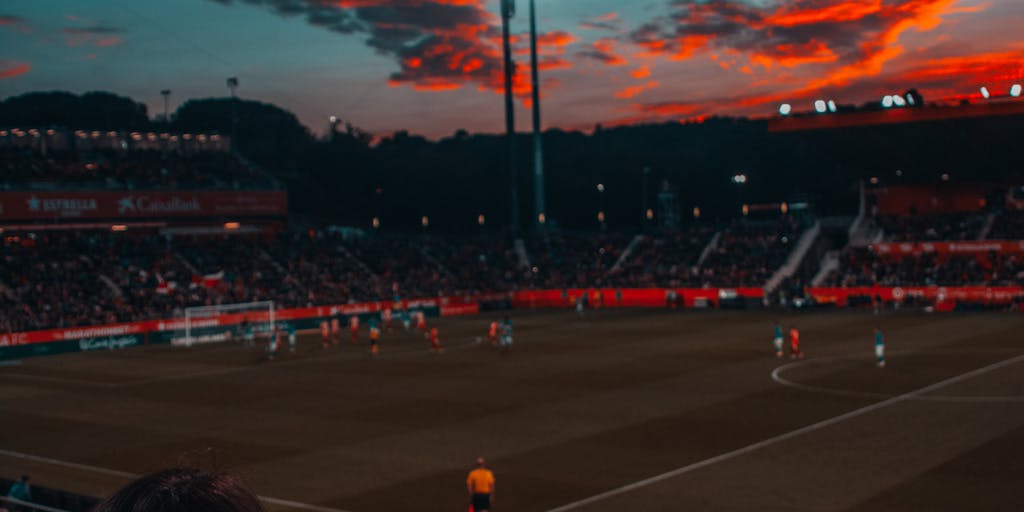 A dynamic shot of a diverse group of fans wearing Corinthians merchandise, gathered in a vibrant urban setting, showcasing their passion for the team. The background features iconic landmarks of São Paulo, symbolizing the team's deep roots in the city. The image captures the energy and community spirit that the Corinthians marketing strategy aims to foster.