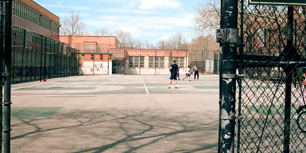 A dynamic photo of a New York City FC player in action, dribbling the ball down a city street, with blurred city life in the background. This image symbolizes the team's urban identity and connection to the city, showcasing the player as a local hero.