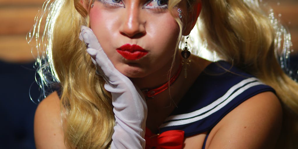 A close-up of a young fan wearing a Broncos jersey, face painted in team colors, holding a sign that reads 'Broncos Country, Let's Ride!' The photo captures the passion and dedication of the fanbase, making it relatable to potential new fans.