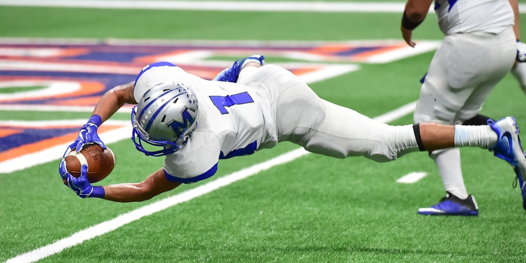 A dynamic action shot of a Broncos player making a game-winning touchdown, with fans in the background cheering wildly. This image conveys the thrill of the game and the emotional connection fans have with their team, perfect for marketing campaigns focused on game day experiences.