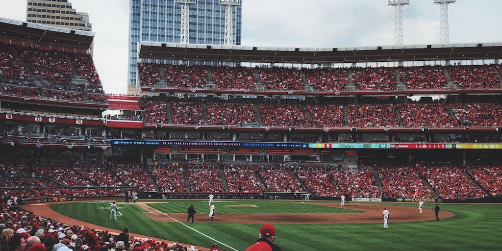 A creative split image showing a Chiefs player in action on one side and a fan in full gear on the other, both celebrating a touchdown. This visual representation emphasizes the connection between the team and its supporters, illustrating the emotional impact of the Chiefs' marketing efforts.