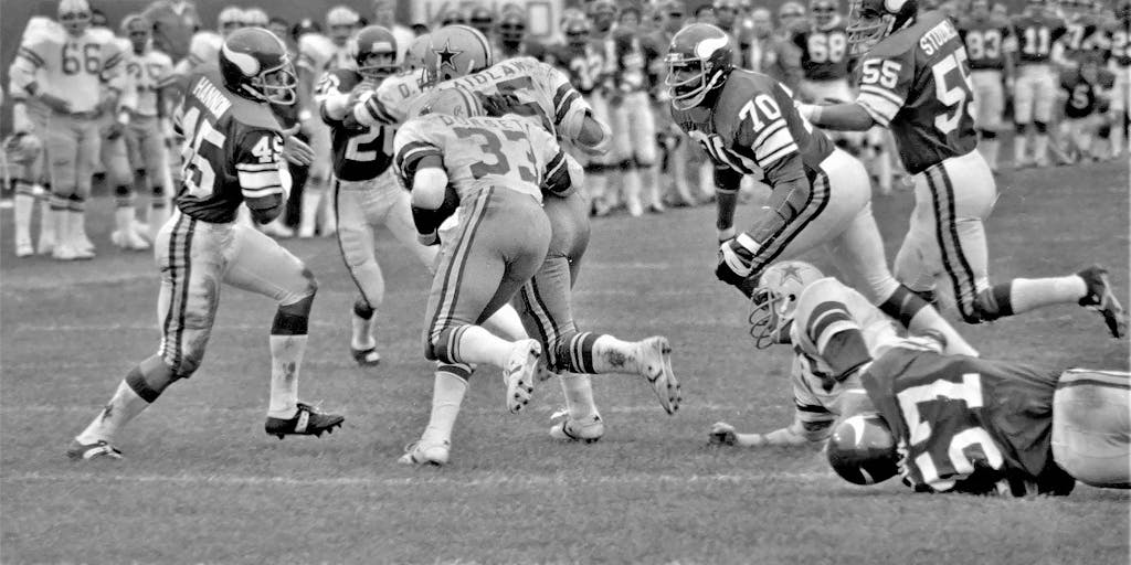 A close-up of a young fan wearing a Minnesota Vikings jersey, face painted in team colors, holding a sign that reads 'Skol!' The photo conveys the passion and loyalty of the fanbase, showcasing how the Vikings connect with younger audiences through emotional marketing.