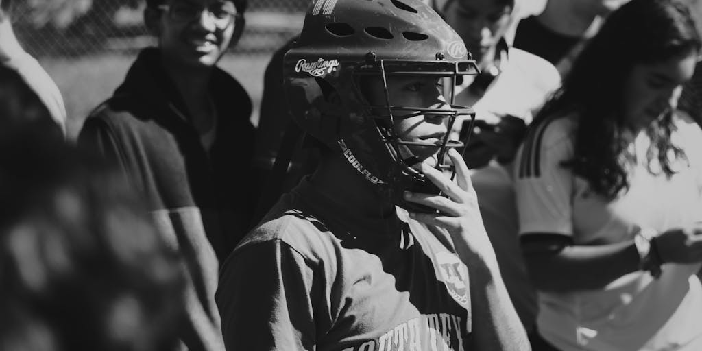 A creative split image showing a 49ers player in action on one side and a community event on the other, such as a youth football camp sponsored by the team. This juxtaposition highlights the 49ers' commitment to community engagement and youth development as part of their marketing strategy.