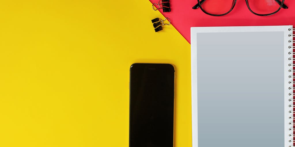 A creative flat lay of various tools and gadgets used for digital marketing, including a smartphone displaying the Rocketreach app, notebooks, pens, and coffee. The arrangement should be aesthetically pleasing, highlighting the theme of productivity and innovation.