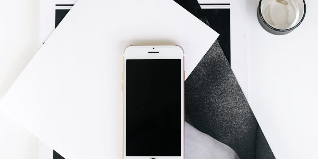 An artistic flat lay of various digital devices (laptop, tablet, smartphone) displaying the Folderly interface, surrounded by stationery items like pens, sticky notes, and a coffee cup, conveying a modern and tech-savvy approach to email management.