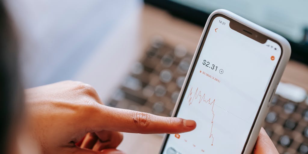 A close-up shot of a smartphone screen displaying a vibrant app interface that shows instant pricing for various products. The background features a blurred shopping environment, hinting at a retail setting. The focus is on the screen, showcasing the ease of accessing prices instantly.