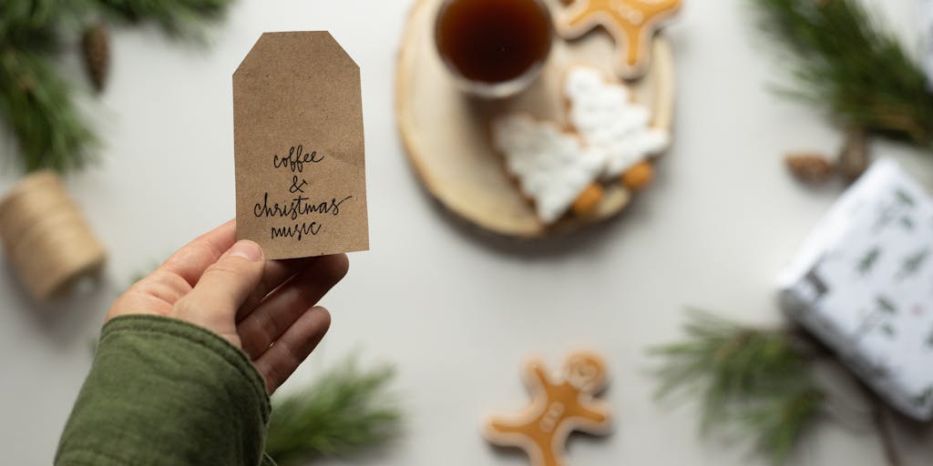 A close-up shot of a colorful price tag hanging from a stylish drip coffee cup, with the tag displaying the word 'Dripify' in bold letters. The background features a blurred café setting, emphasizing a cozy atmosphere.