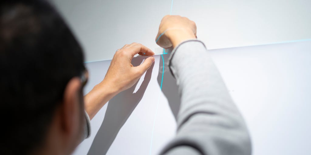 A dynamic image of a business professional pointing at a large screen displaying Smartlead's pricing tiers during a presentation. The audience in the background should be engaged, showcasing the importance of pricing in decision-making.