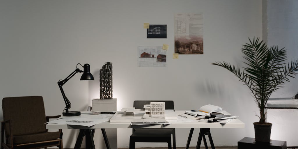 A close-up shot of a rocket model placed on a desk with a laptop open to the Rocket Reach pricing page. The background features a notepad with handwritten notes about budgeting for marketing tools, symbolizing the investment in outreach.