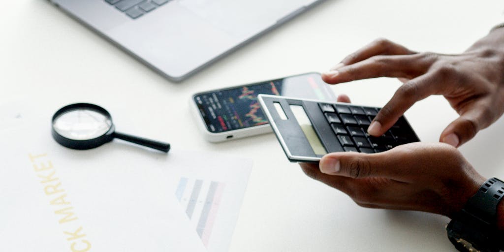 A close-up shot of a smartphone displaying a colorful graph or chart representing pricing tiers for outreach voice services. The background features a blurred office setting, suggesting a professional environment. The focus is on the phone screen, highlighting the data visualization.