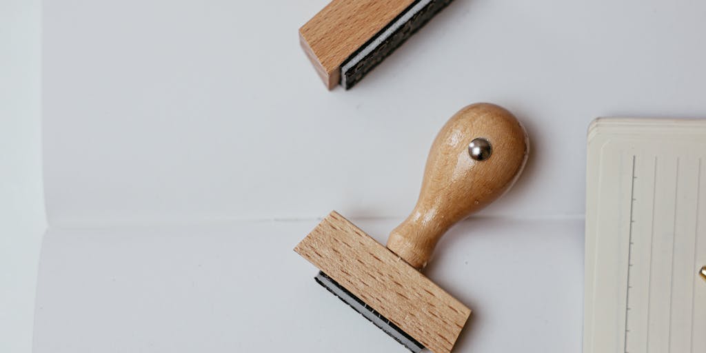 An artistic flat lay of various objects representing different pricing tiers of Waalaxy. Include items like a gold pen for premium pricing, a silver notebook for mid-tier, and a simple pencil for the basic plan. Arrange them on a clean, textured background with a small card that has 'Waalaxy Pricing' written in an elegant font.