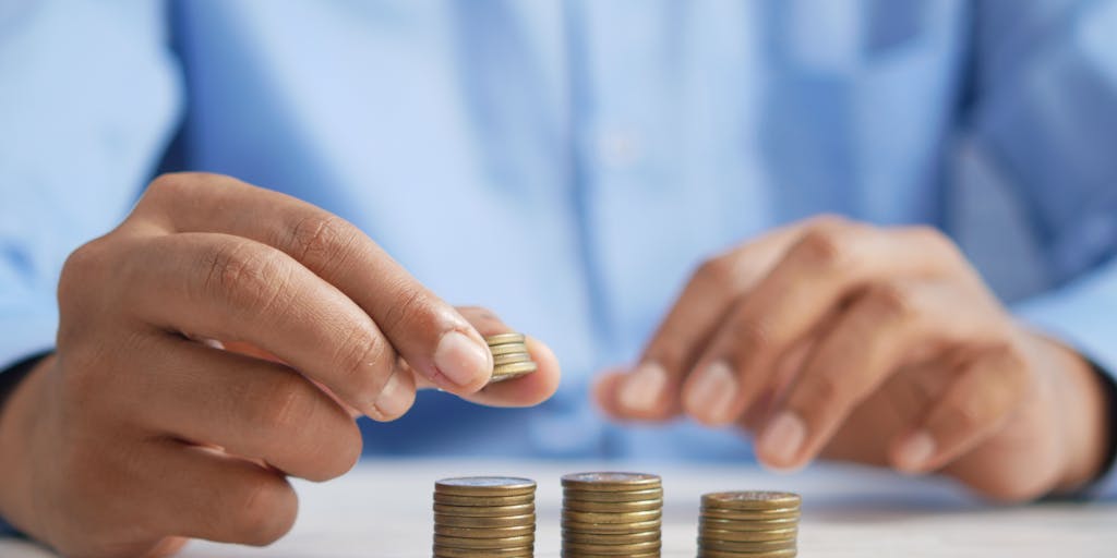 An artistic representation of a scale balancing coins on one side and the AeroLeads logo on the other, symbolizing value for money. The background should be a blurred cityscape, representing business growth and opportunities.