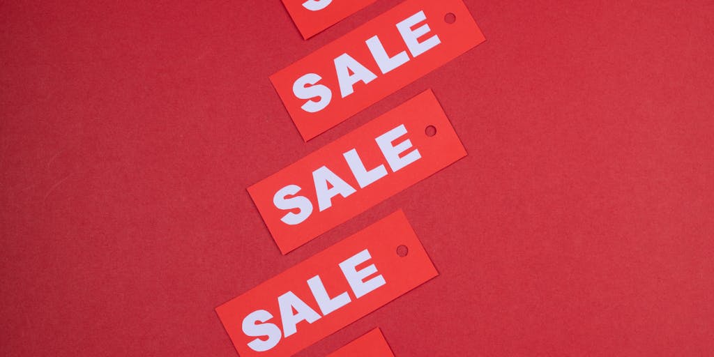 A dynamic image of a diverse group of people in a retail store, all interacting with digital price tags on products. The tags display real-time pricing updates, showcasing the seamless experience of shopping with transparent pricing.