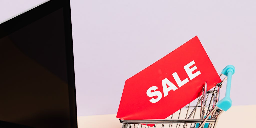 A close-up shot of a digital pricing tag displayed on a sleek, modern device, with a blurred background of a bustling marketplace. The tag shows dynamic pricing changes, symbolizing the innovative nature of Bardeen Pricing.