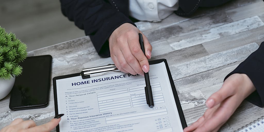 A close-up shot of a person thoughtfully reviewing Yesware pricing on a tablet, with a notepad and pen in hand. The focus should be on the tablet screen showing the pricing options, capturing the moment of decision-making.
