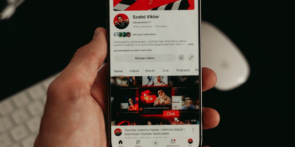 A close-up shot of a smartphone displaying the Lusha app interface, showcasing the pricing plans. The phone should be held in a hand with a blurred background of a modern office environment, emphasizing the accessibility and convenience of using Lusha on-the-go.