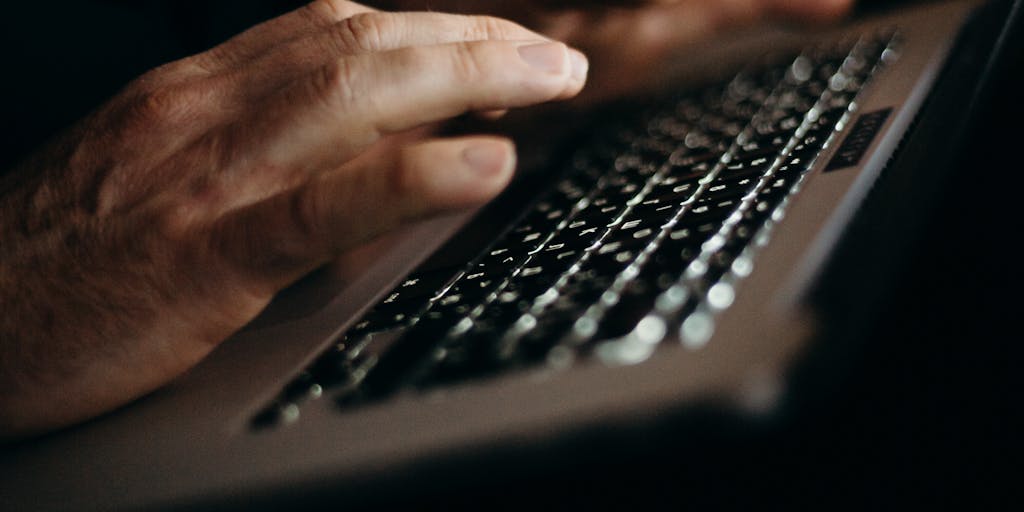 A split-screen image showcasing a person using Jasper AI on one side, with a glowing laptop screen displaying the Jasper interface, and on the other side, a traditional writer surrounded by crumpled papers and a typewriter, highlighting the contrast between modern AI tools and traditional writing methods.