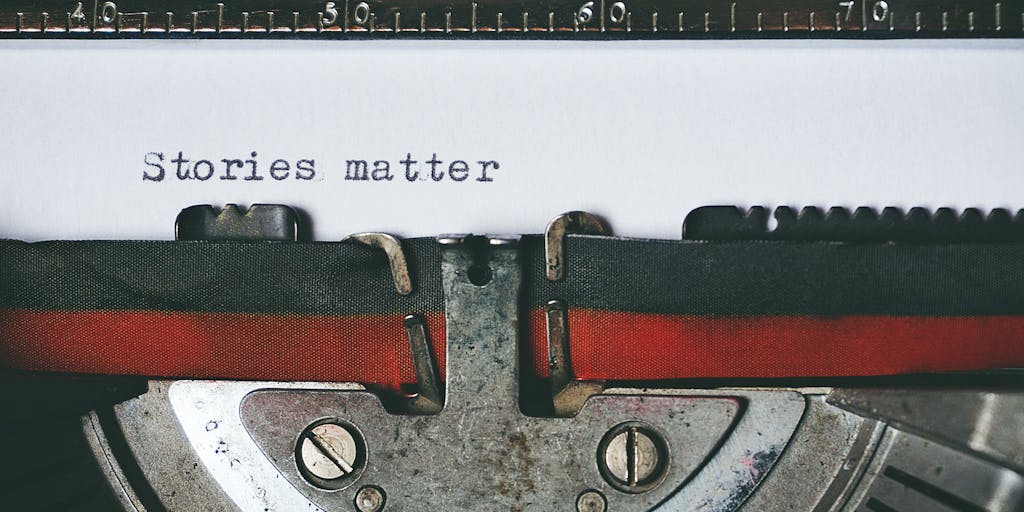 A close-up shot of a vintage typewriter with a sheet of paper emerging from it, featuring the words 'Junia Writer Review' typed out. The background is softly blurred, with a warm light illuminating the typewriter, evoking a sense of nostalgia and creativity.