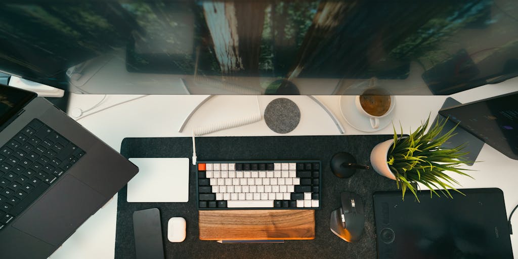 An overhead view of a desk cluttered with writing tools, notebooks, and a smartphone showing the Seowriting.ai app. The scene is vibrant and colorful, with sticky notes and a plant in the background to create an inspiring workspace atmosphere.