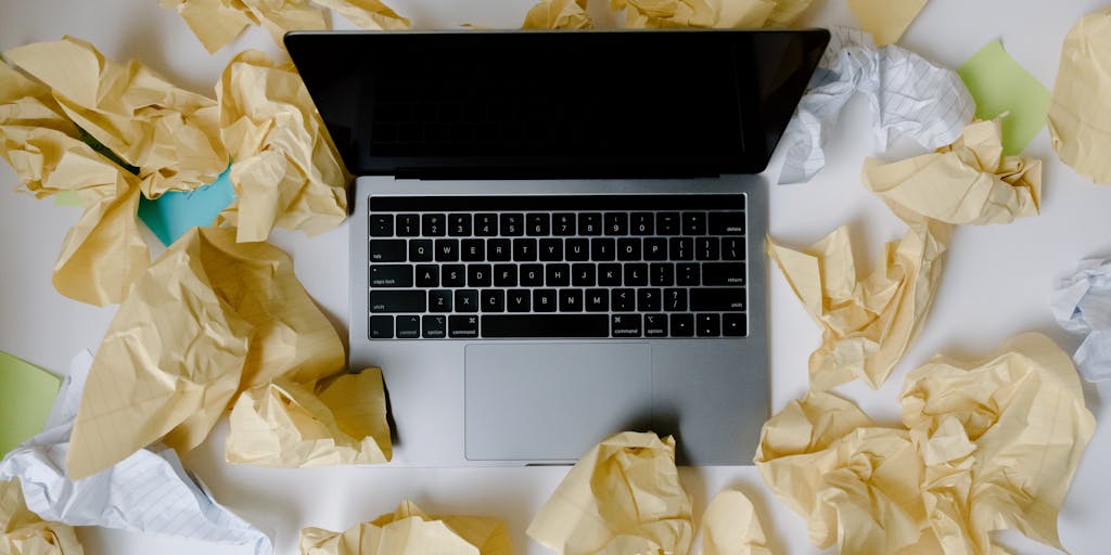 An overhead view of a desk cluttered with notes, a smartphone displaying the Scalenut app, and colorful sticky notes. The scene captures the essence of brainstorming and content creation, with a warm light illuminating the workspace.