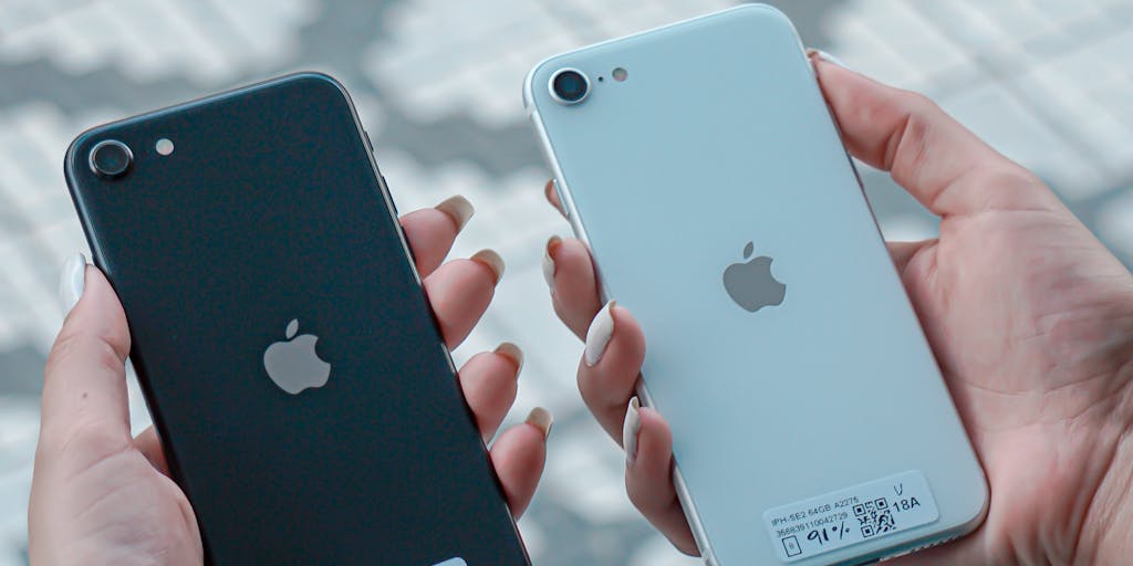 A close-up shot of a hand holding a smartphone displaying a comparison app that lists Outrank.so and its alternatives. The background should be a blurred coffee shop setting, suggesting a casual yet tech-savvy environment where users can make informed choices on the go.