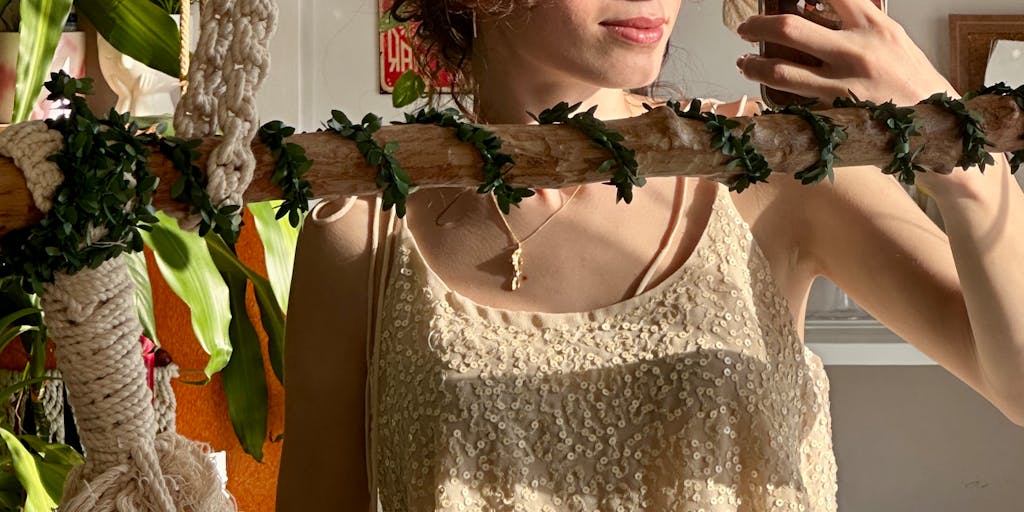 A whimsical scene featuring a koala dressed in a vibrant, bohemian outfit, lounging on a colorful hammock strung between two eucalyptus trees. The background is filled with abstract art and dreamcatchers, creating a fusion of nature and alternative culture.
