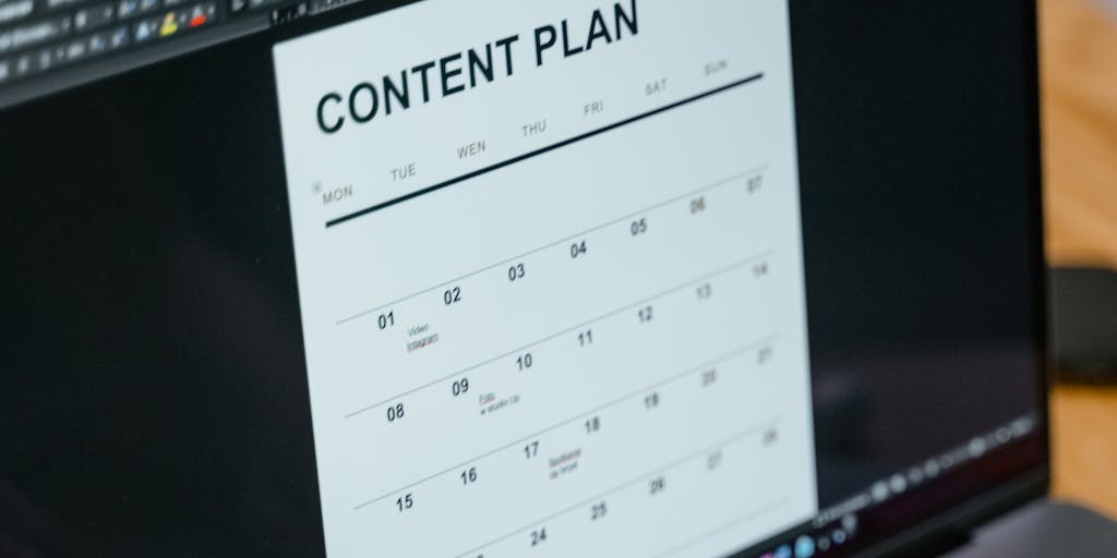 A close-up shot of a laptop screen displaying the Gathercontent interface, with a person’s hands typing on the keyboard. The background is softly blurred to emphasize the screen, and sticky notes with ideas are scattered around the laptop, symbolizing content planning.